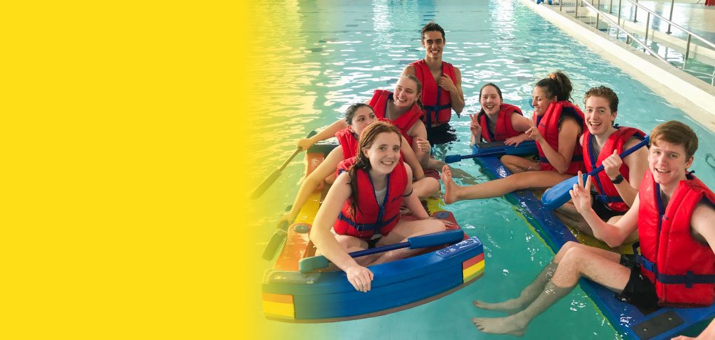Volunteers in the pool with fun yellow background